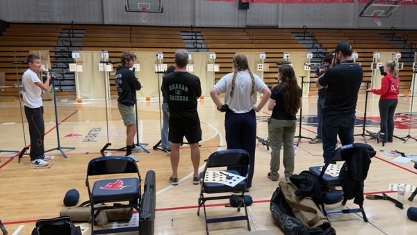 Camper and Reagan Raiders Rifle Team Captain Kiley Driver steps off the line after a great relay poking for advice from Chief McIntyire, Coaches Sahi Weiser and Angus Babcock.