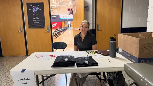 Pictured Jackeline Weiser. Where athletes checked in and got their equipment verified for camp and were handed their camp t-shirt. Photo credit Briana Weiser. Briana helped check in campers and go through their bags as well to check off equipment.