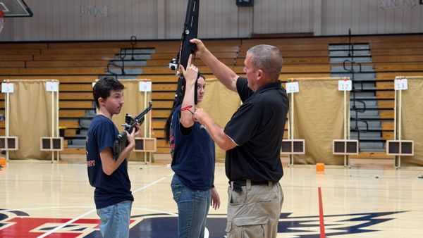 Camp Director CW3 Tiddy works with an athlete on ensuring the rifle's set up was correct for one of our newer to the sport athletes.